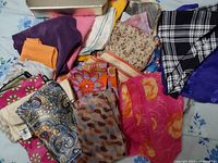 Image showing multiple colorful scarves with different patterns laid out loosely.