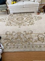 Central medallion and border detail under sofa