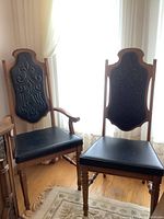 Two chairs by window: one with arms, one without.