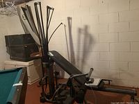 Overall assembled Bowflex unit in basement against cinderblock wall