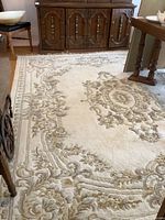 Full view of 8x10 wool area rug under dining table and sideboard