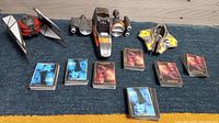 Photo of 7 stacks of Young Jedi Star Wars collectible cards and three vehicle models