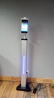Full view of iTechs SmartScan Prime digital thermometer on silver stand with vertical blue LED light strip.