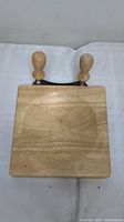 Top view showing the wooden cutting board with the rocker chopper handles visible at the top edge.