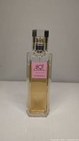 Front view of Hot Couture Givenchy perfume bottle showing label and liquid level