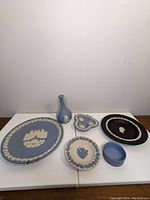 Full set view of Wedgwood blue jasperware plates and vase