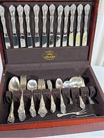 Full view of flatware set in original wood box showing knives, forks, spoons and servers