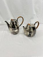Two pitchers side by side on white background