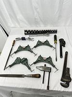 Full lot overview showing all Craftsman tools including clamps, wrenches, ratchet and sockets, pipe wrenches, screwdriver, and files arranged on white cloth.