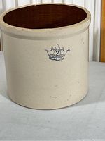 Photo of the full stoneware crock pot showing off-white exterior with a crown logo and number 2