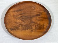 Top view of the round myrtlewood platter showcasing the natural wood grain and polished finish.