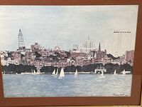 Full view of framed lithograph showing city skyline and sailboats in harbor, signed and dated 1967.