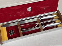 Vintage Gerber three-piece carving set in original hinged aluminum box with red velvet interior and loose Gerber name plate.