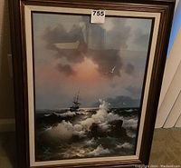Framed print depicting a stormy seascape with a ship on rough waters under a cloudy sky with seagulls.