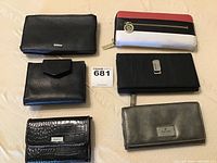 Overview photo showing all 6 wallets arranged on fabric background