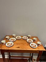 Full set of 6 cups and 6 saucers arranged on wooden table