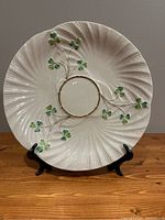 Full front view of the Belleek Shamrock plate showing scalloped edge, raised relief shamrocks, and gold ring detail