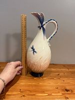 Full view of the pitcher with a ruler showing height approximately 12 inches.