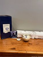 Full lot image showing the porcelain sugar jar with lid, original box (blue with label), styrofoam packaging, and pamphlet.