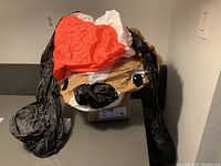 Deflated inflatable dog head with black floppy ears and red Santa hat.