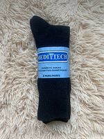 Two pairs of black Medi Tech diabetic socks in original packaging folded neatly, showing the label.