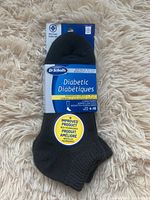 Two pairs of new in packaging Dr. Scholl's diabetic women's low cut socks in black, size 4-10, showing front packaging with product details and branding.