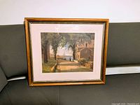Framed D.I. McLeod print showing a pathway with trees and houses, taken from the front at an angle