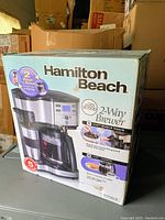 Photo of Hamilton Beach coffee maker box with front view showing brand, model name, and product images.