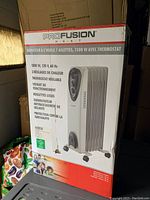 Front and partial side view of the ProFusion Heat 1500W 7-fin oil filled heater in its original box with product image and specifications in French.