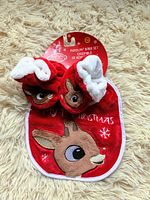 Photo of new baby bib and booties set with Rudolph the Red-Nosed Reindeer design, red color, original packaging tag present.