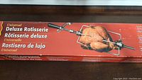 Photo of the rotisserie packaging showing a whole chicken on the rotisserie spit and forks with product name in English, French, Spanish.