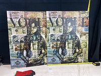 Two identical Vogue art prints 30x24 inches leaning against a dark background, featuring a female silhouette over currency collage.