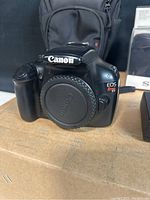 Front view of Canon EOS Rebel T3 DSLR body with body cap attached