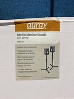 Box label showing Auray Studio Monitor Stands LMS-335 model and features including steel construction, adjustable height, wide base, rubber feet, and included spikes.