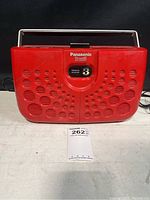 Front view of red Panasonic Stereo 8 track player with carry handle and program indicator 3 visible