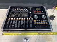Full view of Tascam Digital Portastudio DP-02 showing the front panel with faders, knobs, and buttons.