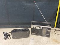 Sony vintage portable radio and GE digital radio alarm clock side by side on floor