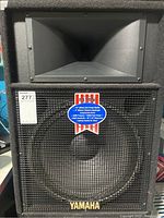 Front view of Yamaha S115lv speaker showing the 15-inch woofer, compression driver, and Yamaha logo.