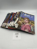 Stack of 31 Buffy The Vampire Slayer comic books showing multiple spines creating a fan shape