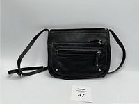 Front view of Danier black leather bag showing the zippered pocket, adjustable shoulder strap, and pebble grain texture.