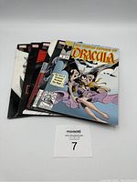 Front view of all six Dracula comics spread out showing colorful and gothic themed covers.