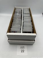 Two-row box filled with sleeved Topps Chrome Formula One trading cards viewed from front.