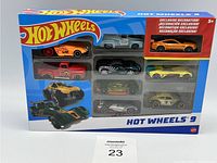 Front view of unopened Hot Wheels 9 Pack Exclusive box showing all nine diecast cars against blue background