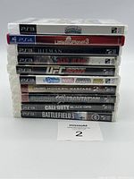 Stacked image of 11 game cases showing titles and conditions for the lot