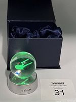 Crystal ball with green light illumination featuring Star Trek Enterprise inside, on Kaitnax base and open box with satin lining
