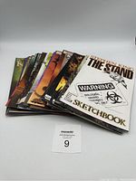 Front view of a spread fan of 22 Stephen King comics showing various covers stacked loosely.