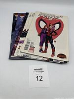 Stack of six The Amazing Spider-Man comic books showing front covers with various Spider-Man themed artwork.