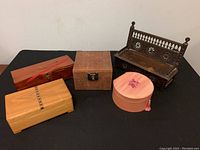 Full lot display of antique carved hall bench and four vintage storage/jewelry boxes.