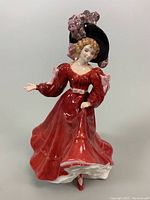 Front view of Royal Doulton "Patricia" HN3365 figurine showing detailed red dress and large feathered hat.