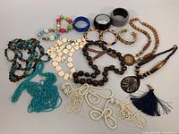 Overall assortment of costume jewelry including necklaces and bangles